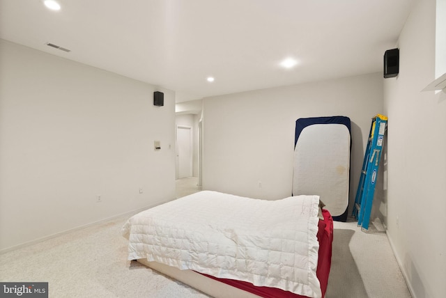 bedroom with light colored carpet, recessed lighting, and baseboards