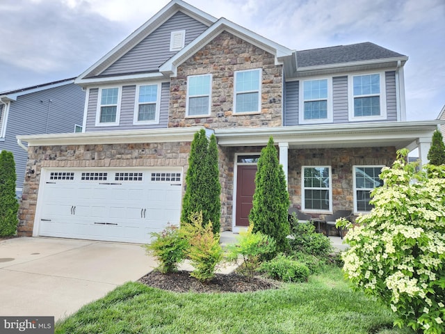 craftsman house with stone siding, driveway, and an attached garage