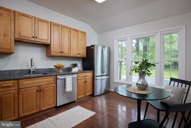 2723 Deer Ridge Dr, Silver Spring, MD 20904 - kitchen with appliances with stainless steel finishes, vaulted ceiling, a sink, dark wood-style flooring, and brown cabinetry