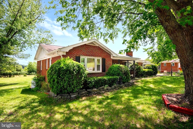 350 Poorhouse Rd, Winchester, VA 22603 - view of home's exterior featuring a chimney, a lawn, and brick siding
