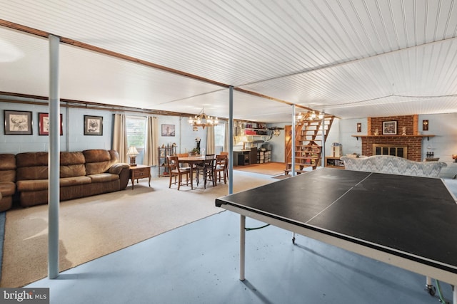 350 Poorhouse Rd, Winchester, VA 22603 - rec room featuring finished concrete floors, a fireplace, and a chandelier