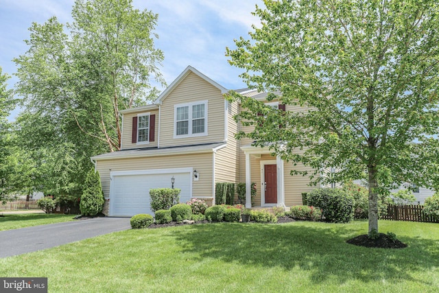 view of front of home with a garage and asphalt driveway