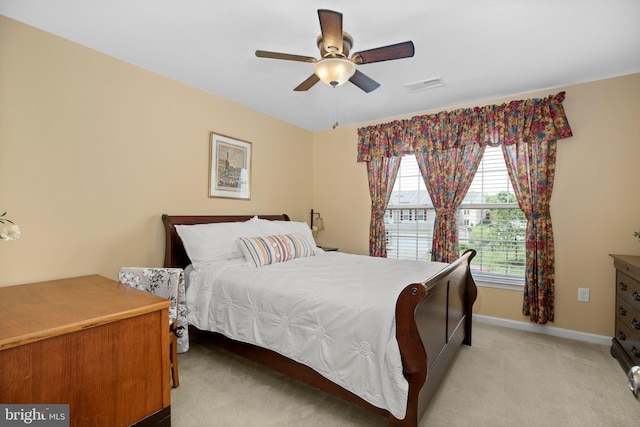bedroom with light carpet, baseboards, and ceiling fan