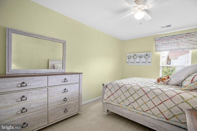 bedroom featuring light carpet, baseboards, and ceiling fan