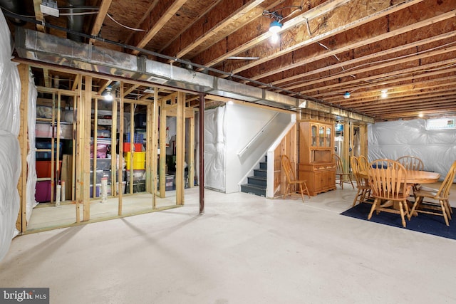 unfinished basement featuring stairway
