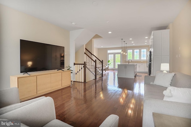 living room featuring wood-type flooring, stairway, and recessed lighting
