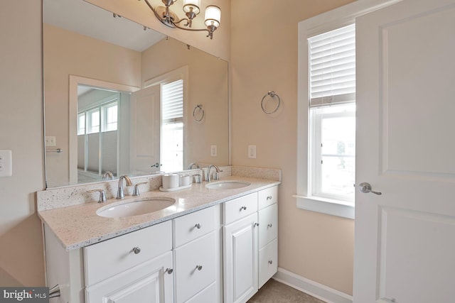 bathroom with a chandelier and double vanity
