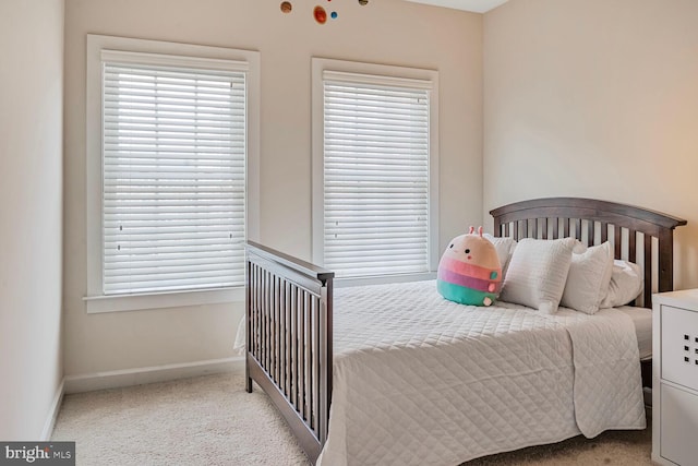carpeted bedroom with baseboards