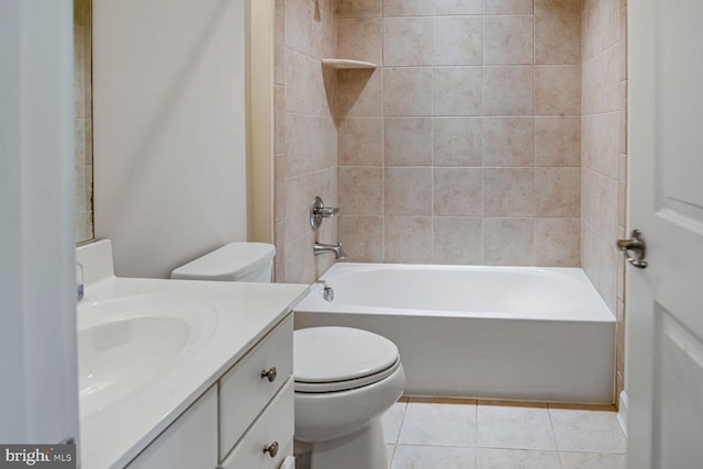 bathroom featuring toilet, tile patterned floors, vanity, and bathing tub / shower combination