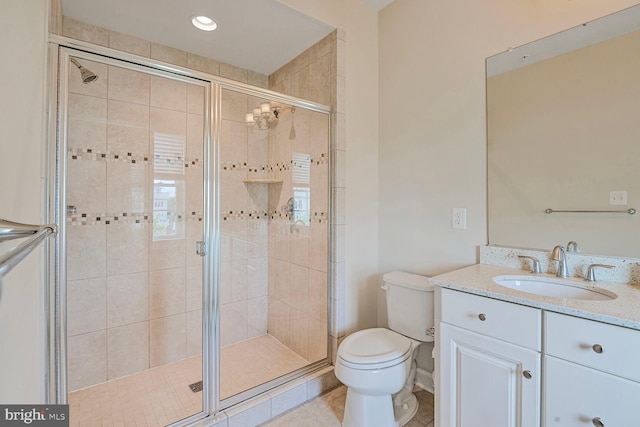 full bath with a shower stall, toilet, vanity, and tile patterned flooring