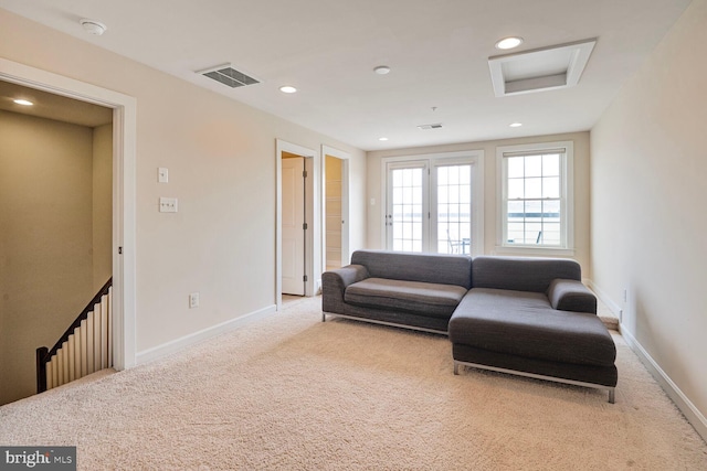 living room with carpet, attic access, baseboards, and recessed lighting