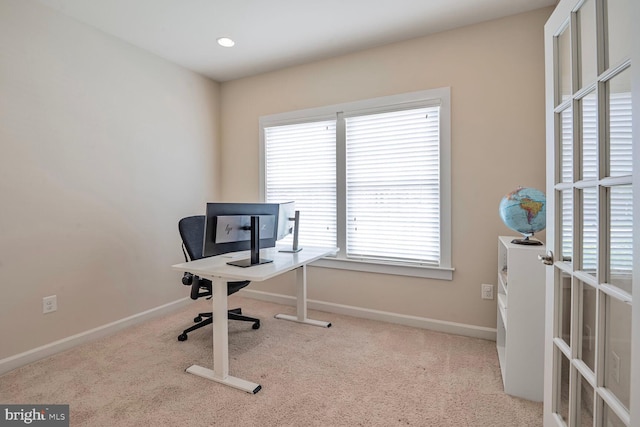 carpeted office featuring plenty of natural light and baseboards