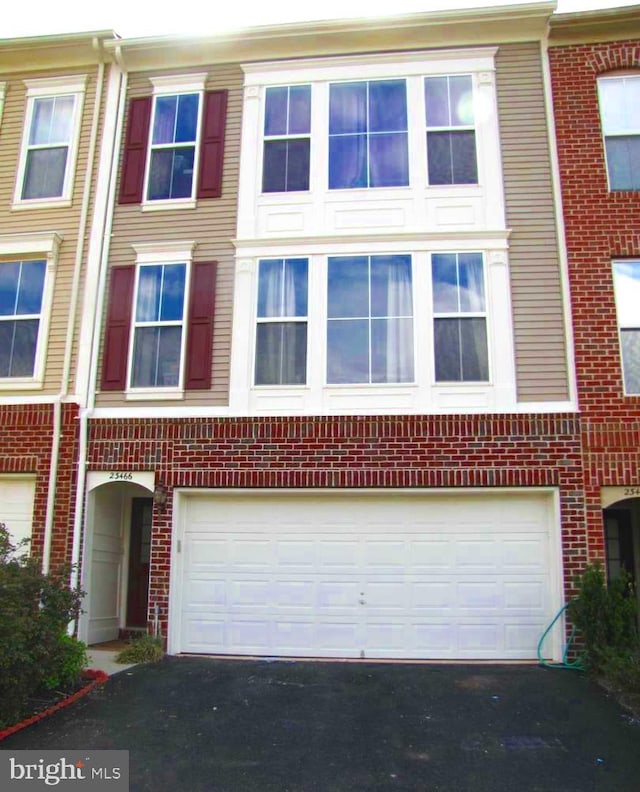 23466 Twin Falls Ter, Brambleton, VA 20148 - multi unit property with asphalt driveway, a garage, and brick siding