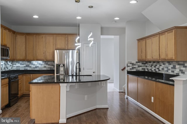 23466 Twin Falls Ter, Brambleton, VA 20148 - kitchen with appliances with stainless steel finishes, a sink, dark wood finished floors, decorative backsplash, and a center island with sink