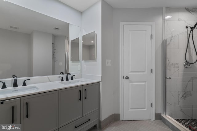 23466 Twin Falls Ter, Brambleton, VA 20148 - bathroom with double vanity, a shower stall, and baseboards