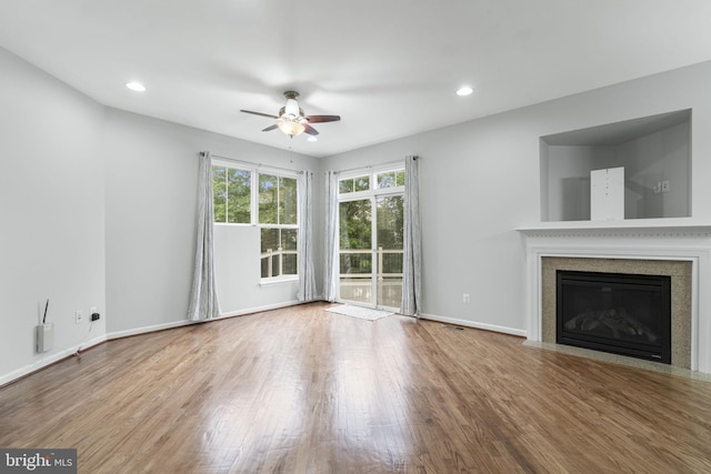 23466 Twin Falls Ter, Brambleton, VA 20148 - unfurnished living room with ceiling fan, wood finished floors, a fireplace with flush hearth, baseboards, and recessed lighting