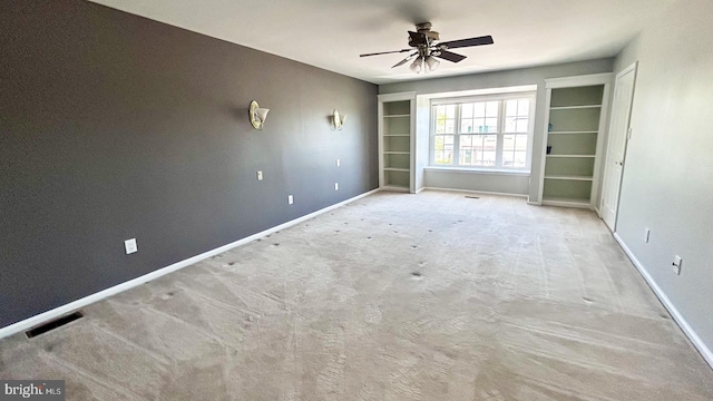 carpeted empty room with baseboards and ceiling fan