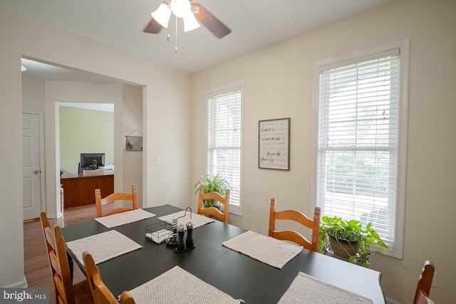 dining room with a ceiling fan and wood finished floors