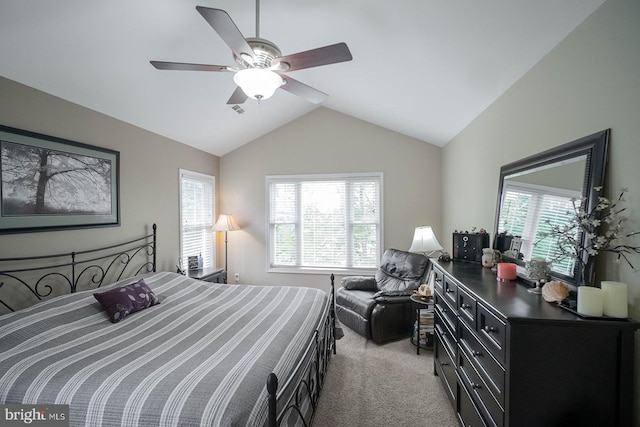 bedroom with light colored carpet, multiple windows, vaulted ceiling, and ceiling fan