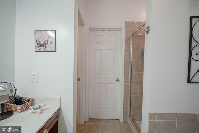 full bathroom with vanity, tile patterned flooring, and a shower stall