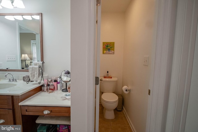 bathroom featuring tile patterned flooring, vanity, and toilet