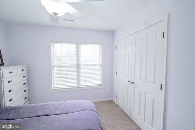 bedroom featuring carpet, a closet, a ceiling fan, and baseboards