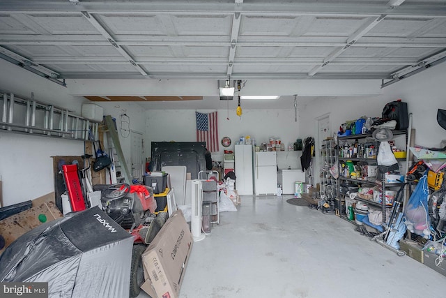 garage with a garage door opener and freestanding refrigerator