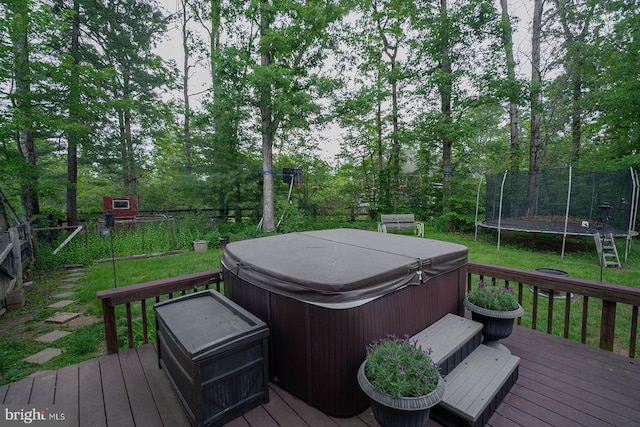 deck featuring a hot tub and a trampoline