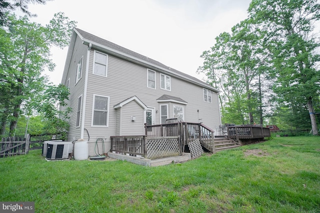 back of house with central AC unit and a deck