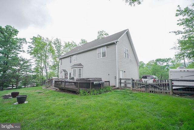 rear view of property with a deck and a gate