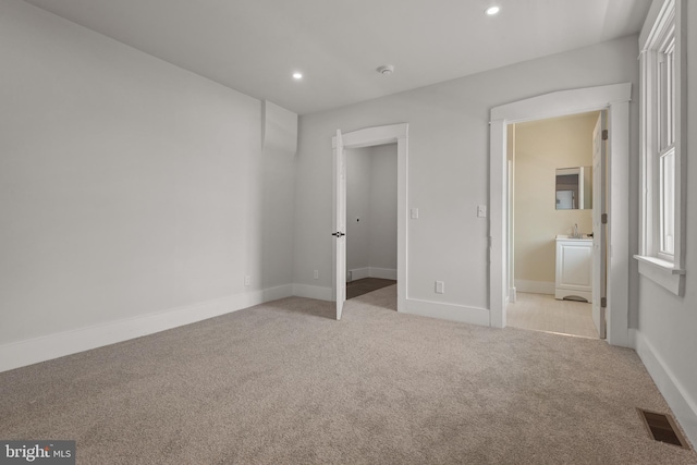 442 S Prince St, Lancaster, PA 17603 - unfurnished bedroom with light colored carpet, recessed lighting, baseboards, ensuite bath, and a spacious closet