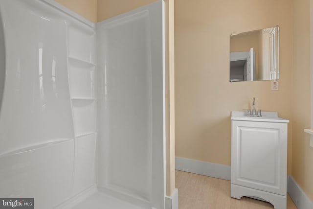 442 S Prince St, Lancaster, PA 17603 - bathroom with a shower, vanity, baseboards, and wood finished floors