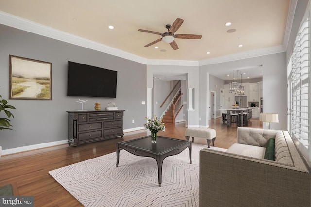 living area featuring a ceiling fan, dark wood-style flooring, stairway, healthy amount of natural light, and recessed lighting