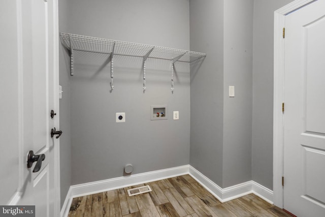 washroom with washer hookup, wood finished floors, electric dryer hookup, and baseboards