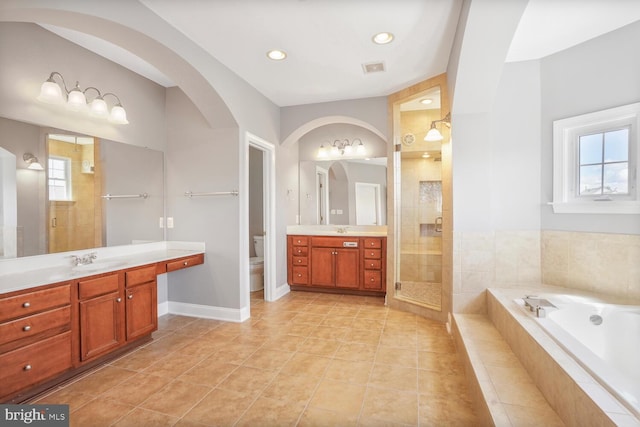 bathroom with healthy amount of natural light, a stall shower, toilet, a bath, and recessed lighting