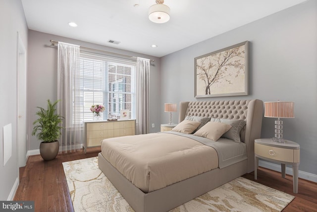 bedroom featuring baseboards, wood finished floors, and recessed lighting