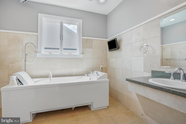 bathroom with tile walls, a sink, a bath, and tile patterned floors