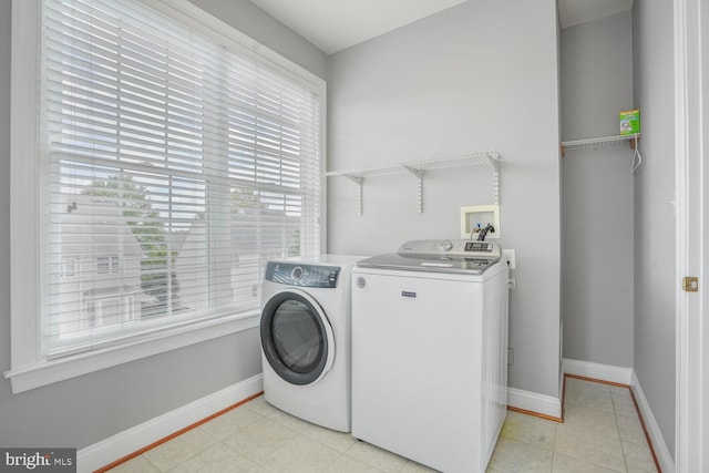laundry room featuring washer and dryer and baseboards