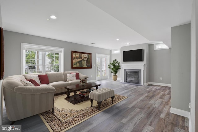 living room featuring plenty of natural light, baseboards, wood finished floors, and recessed lighting
