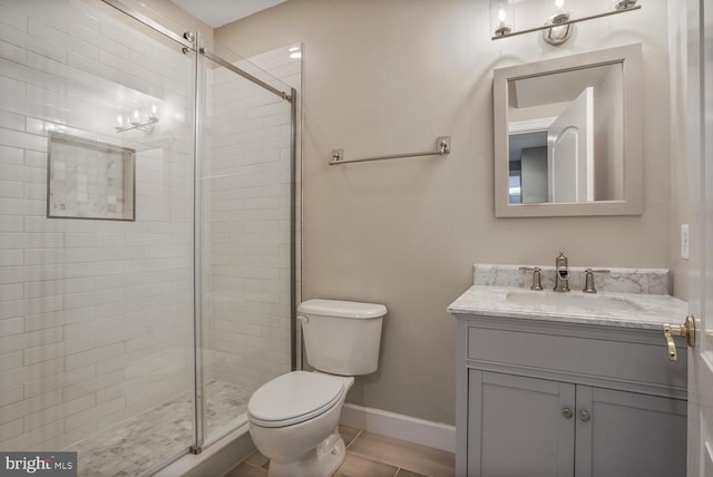 full bathroom with toilet, a shower stall, vanity, and baseboards