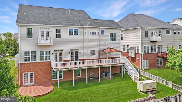 rear view of house with french doors, brick siding, central AC unit, and a deck