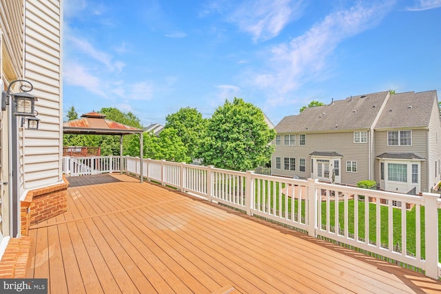 wooden terrace featuring a gazebo