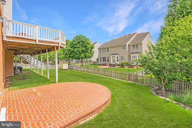 view of yard with a patio, a deck, and stairway