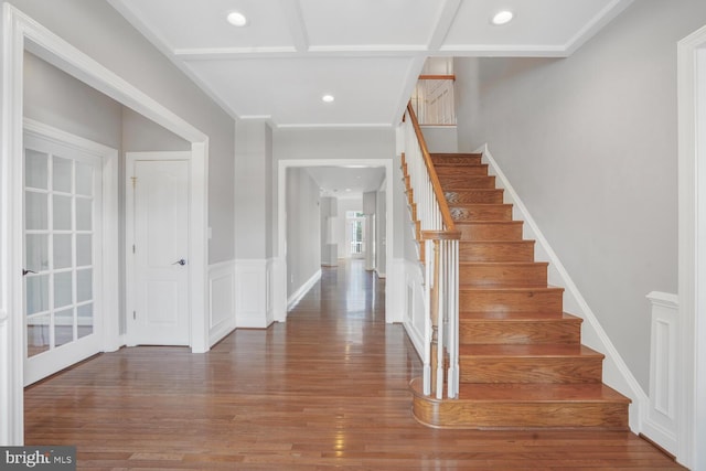 foyer entrance with wood finished floors, stairs, and recessed lighting