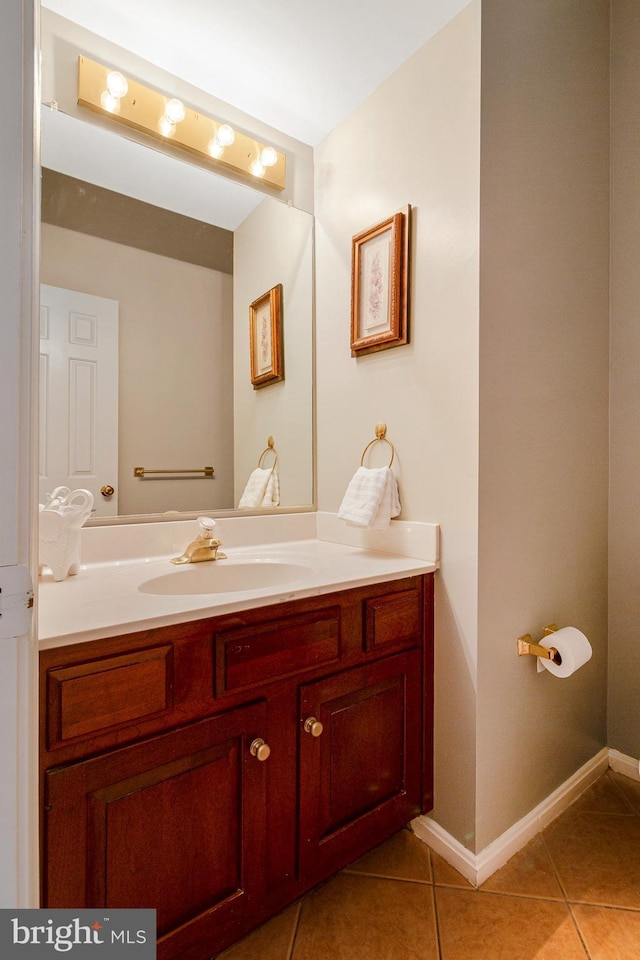 bathroom with tile patterned floors, vanity, and baseboards