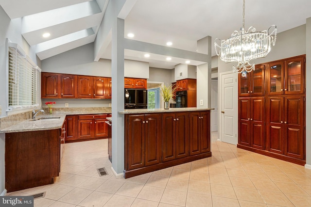 kitchen with light tile patterned floors, a sink, lofted ceiling, a chandelier, and light stone counters
