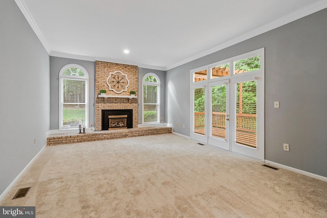 unfurnished living room with crown molding, carpet, baseboards, a brick fireplace, and recessed lighting