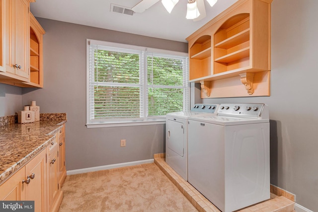 washroom featuring independent washer and dryer, baseboards, cabinet space, light carpet, and ceiling fan