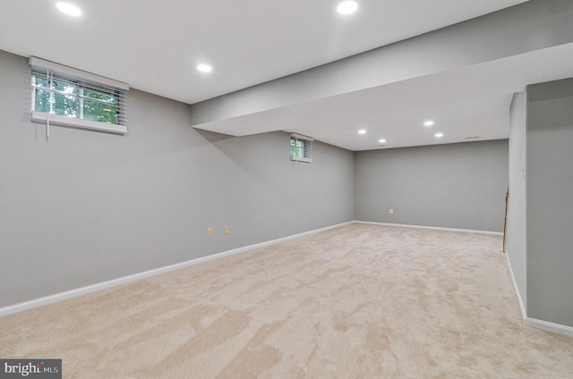 below grade area featuring carpet flooring, recessed lighting, baseboards, and healthy amount of natural light