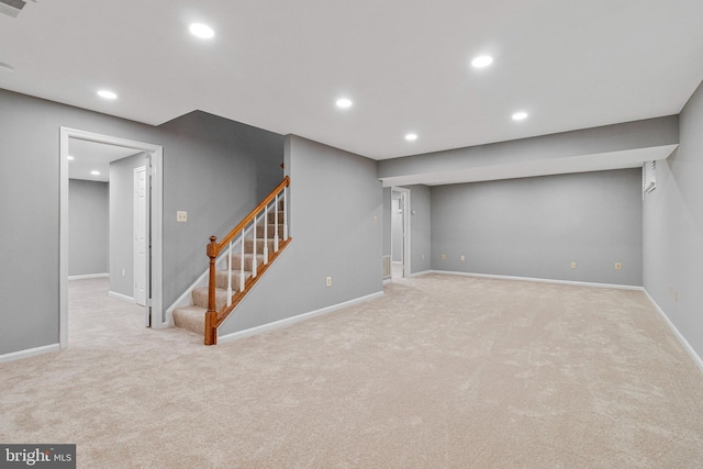 finished basement with carpet floors, recessed lighting, stairway, and baseboards